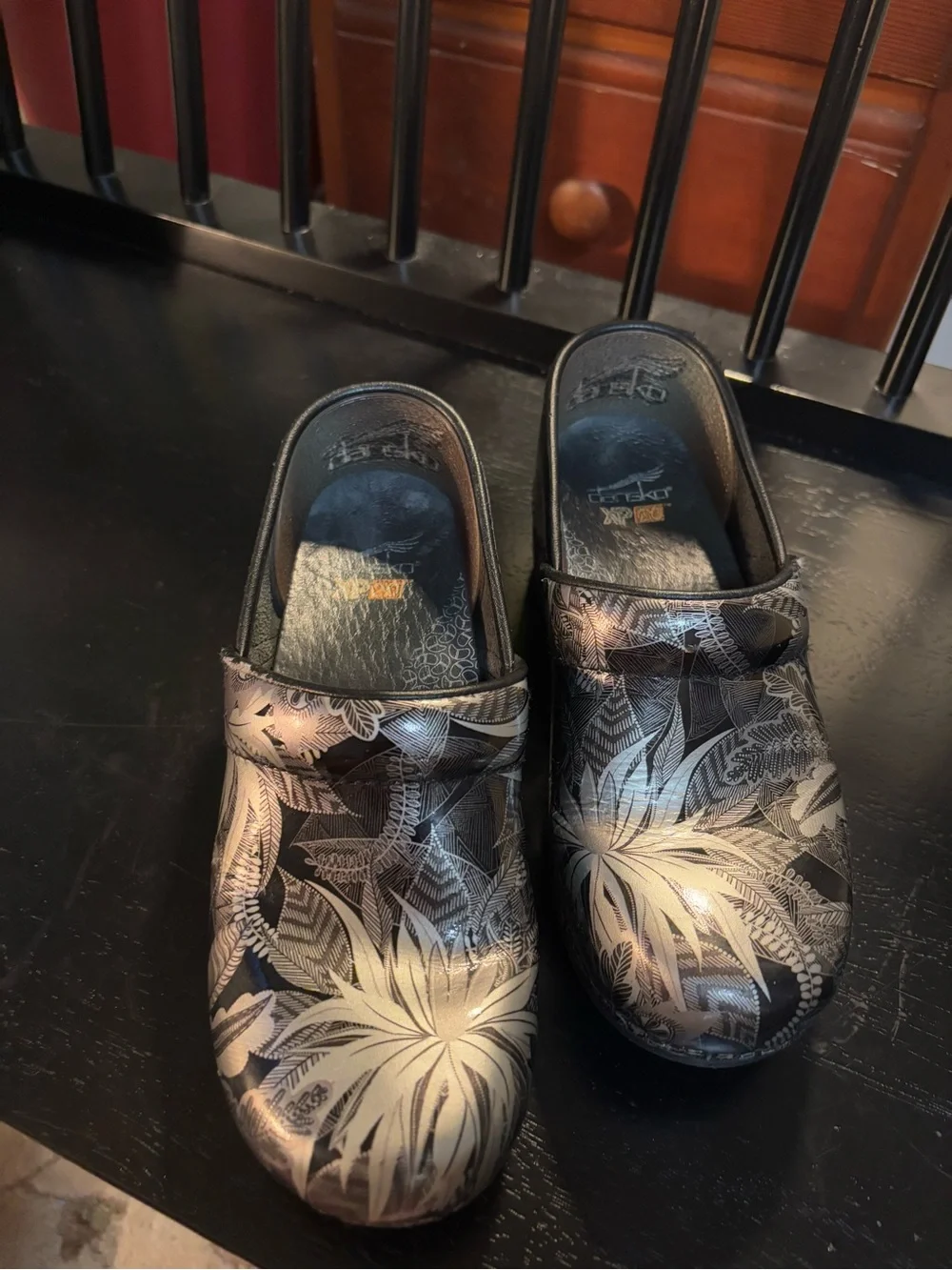 Dansko Black Clogs with Silver Floral Print
